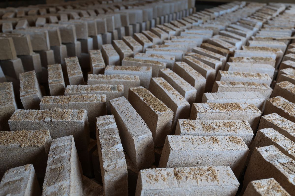Qu bricks laid out in rows to dry — the grain starter that seeds every baijiu fermentation