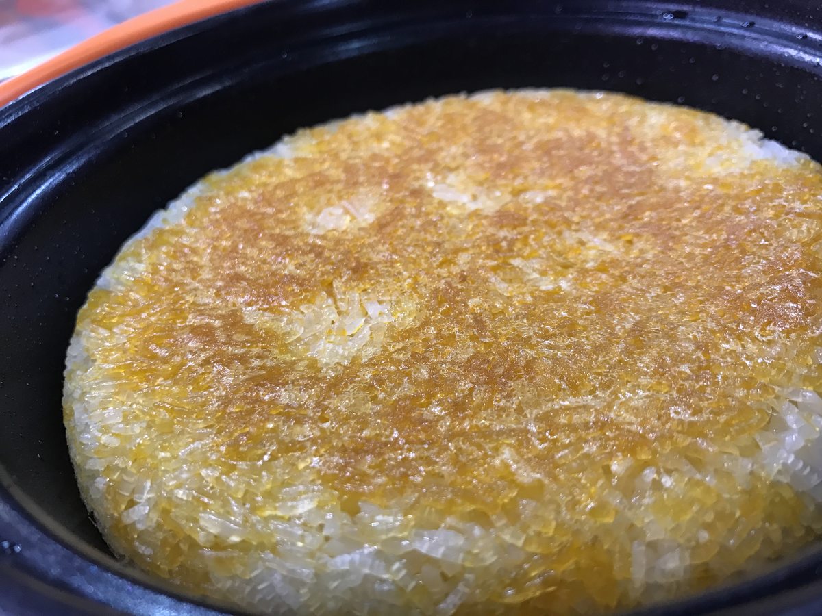 Claypot Rice crust — the golden guoba layer scraped loose from the bottom of a blackened clay pot