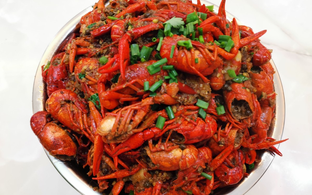 Crayfish — a steel basin piled with red crayfish, garlic, chilli and coriander through the lot