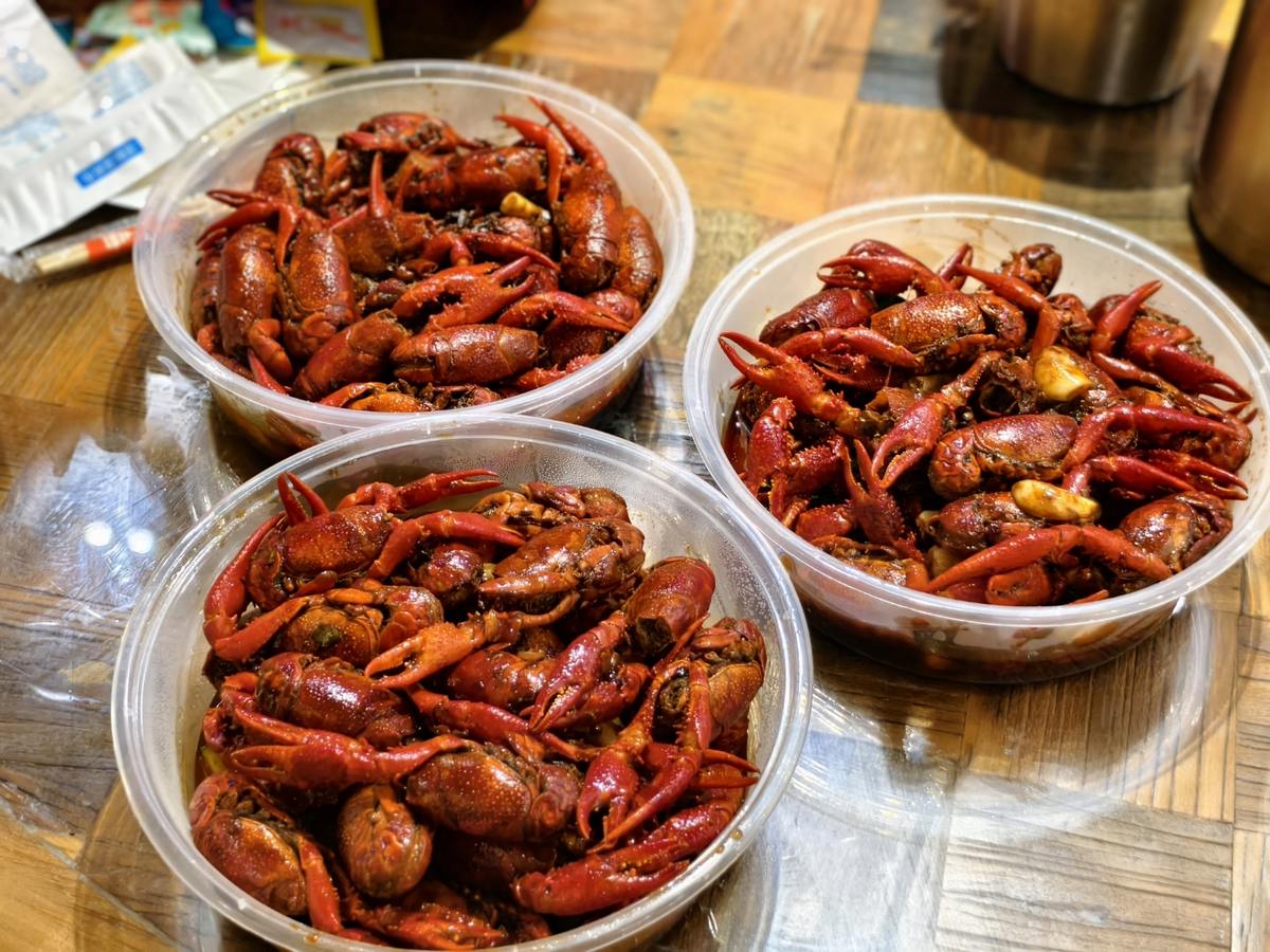 Crayfish at a plastic-covered table, three basins deep, which is how the night actually looks