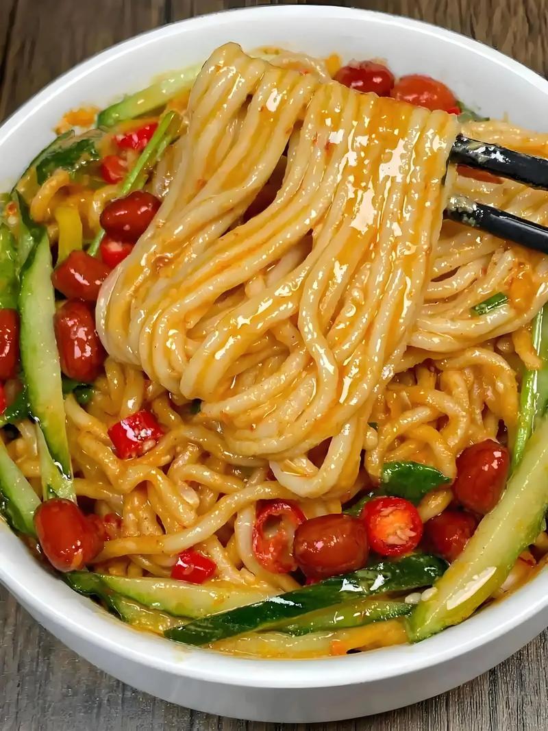 Dan Dan Noodles — a bowl of springy wheat noodles coated in sesame-chili sauce with minced pork and scallions