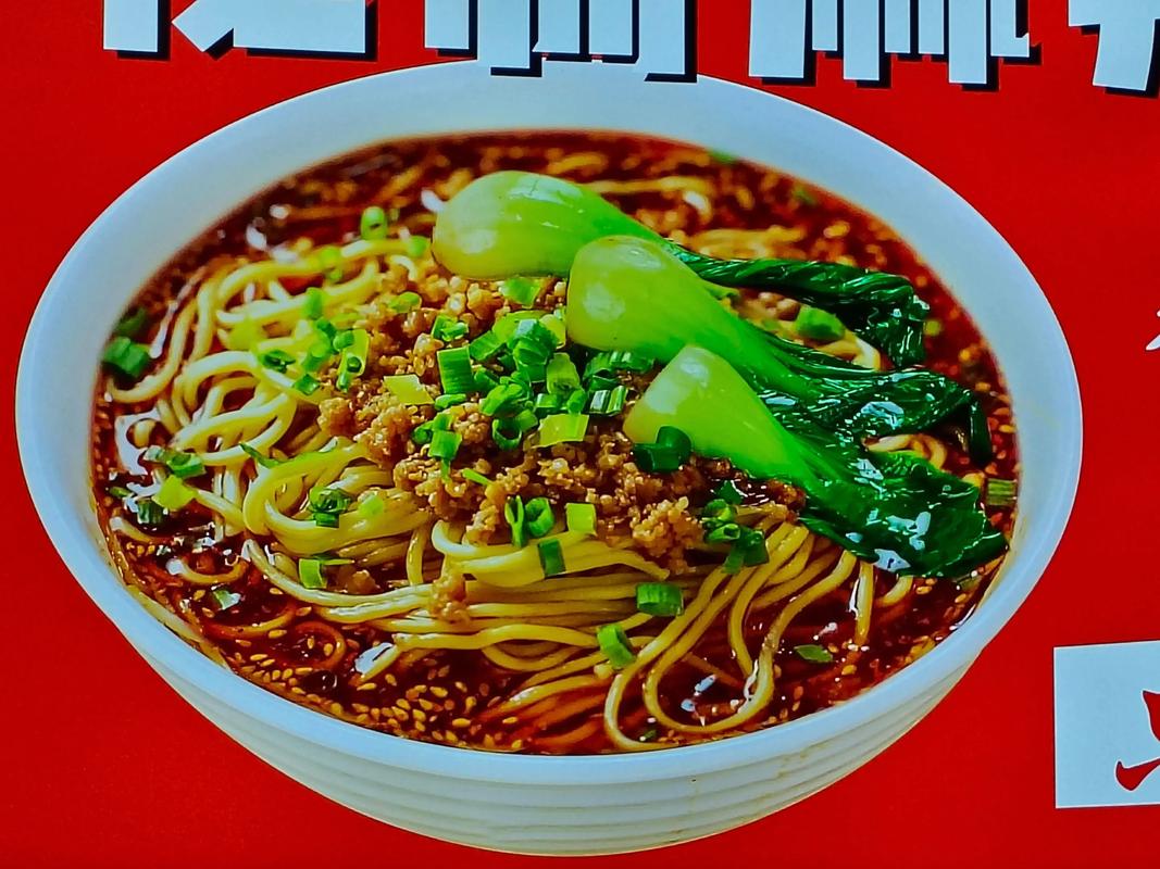 Dan Dan Noodles — closeup of the glossy chili oil and sesame-coated noodles