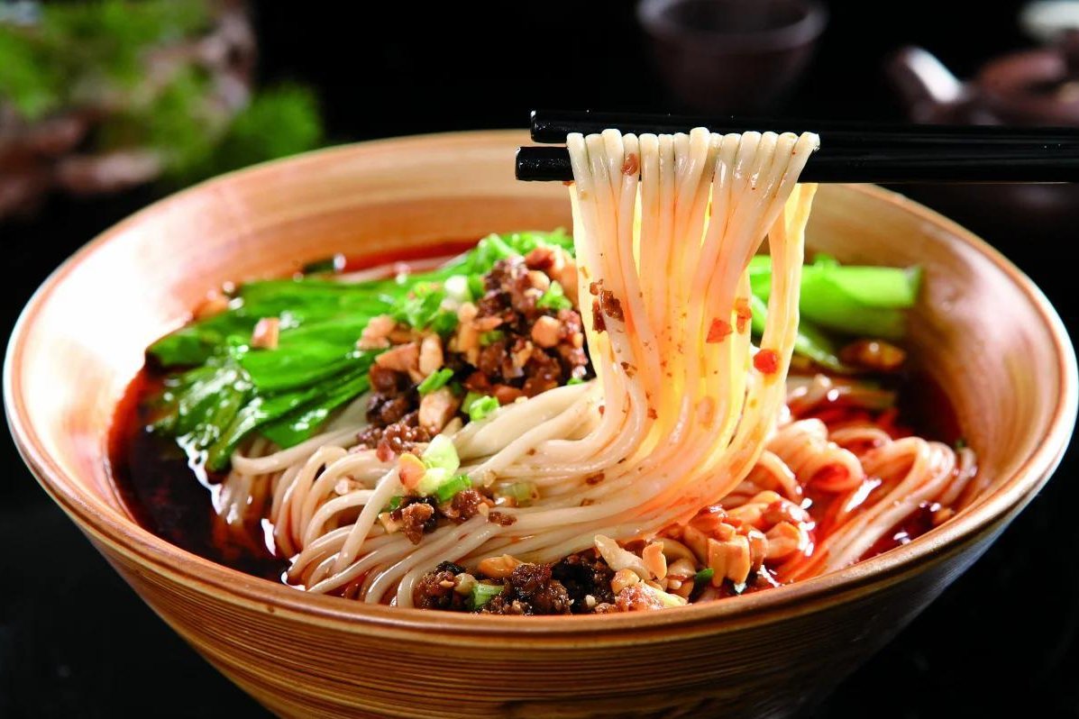 Dan Dan Noodles — the bowl as served, pork and scallions scattered on top