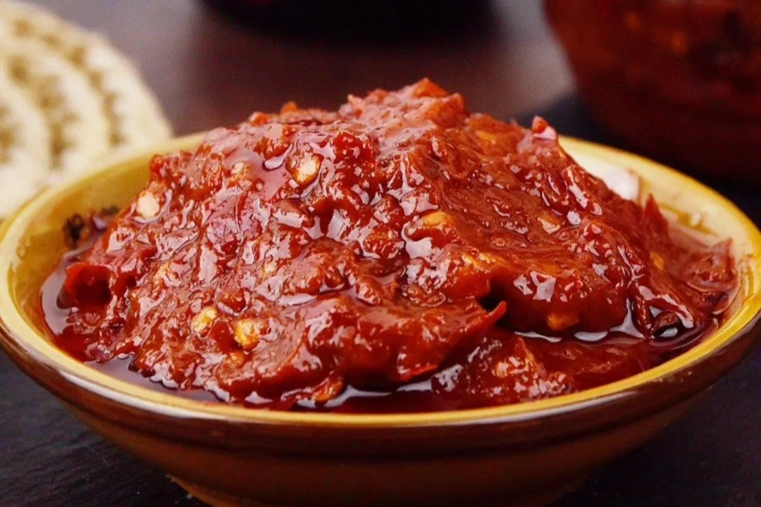 A jar of Pixian doubanjiang — brick-red fermented broad bean paste, the soul of Sichuan cooking