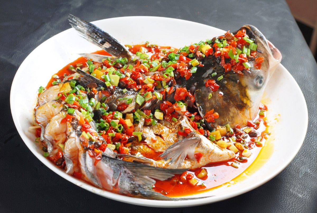 Duo Jiao Fish Head close-up — the white flesh and cheek under the chilli and garlic, still steaming