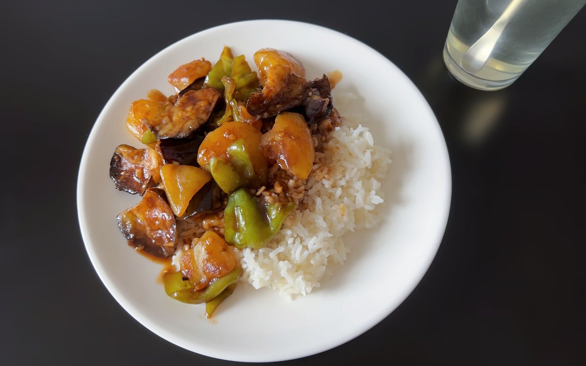 Earth's Three Fresh spooned over plain white rice on a white plate