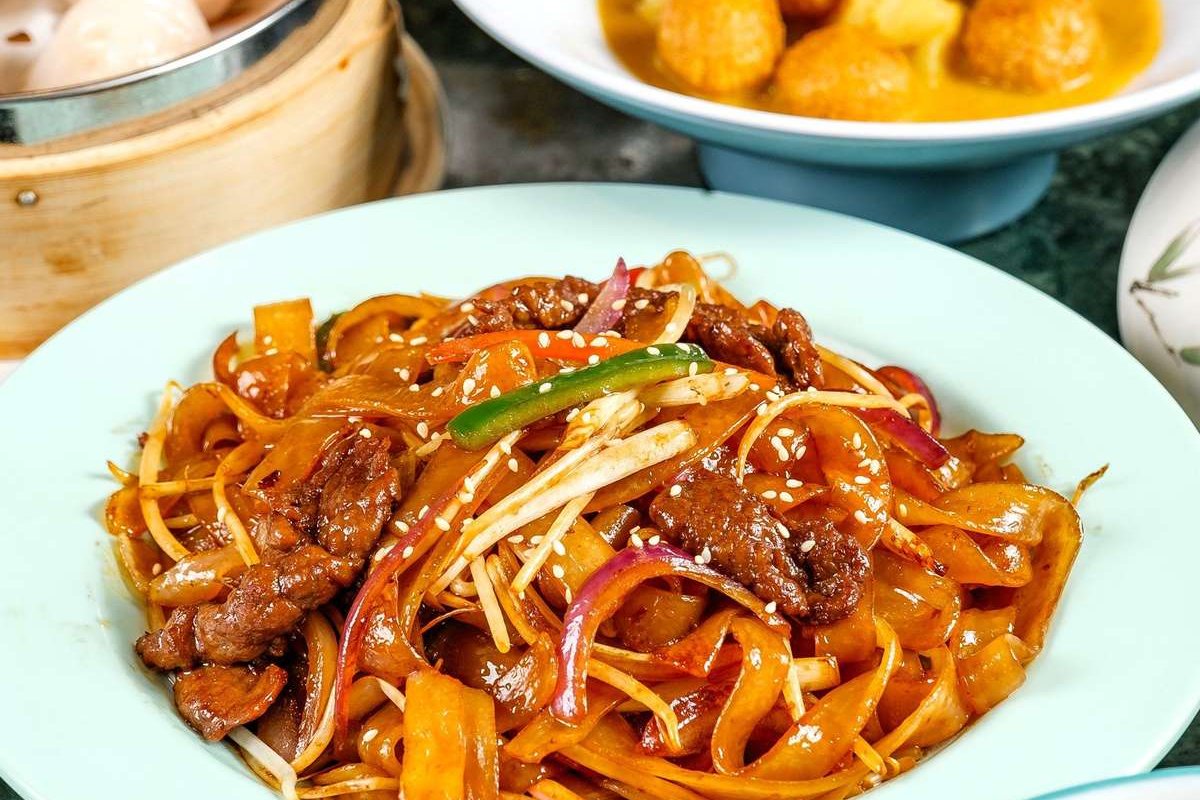 Gan Chao Niu He on a white plate — finished dish with chopsticks ready