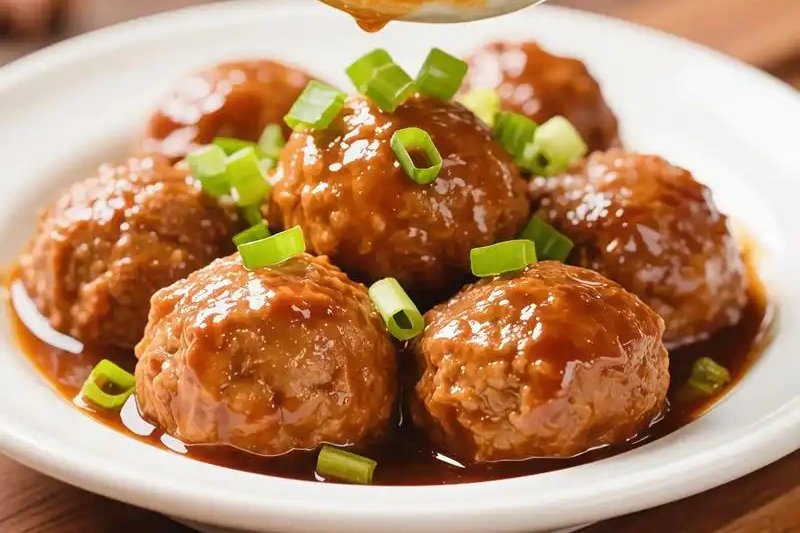 Lion’s Head Meatball — a massive glistening pork meatball in dark clay pot, napa cabbage wilting around it, steam curling upward