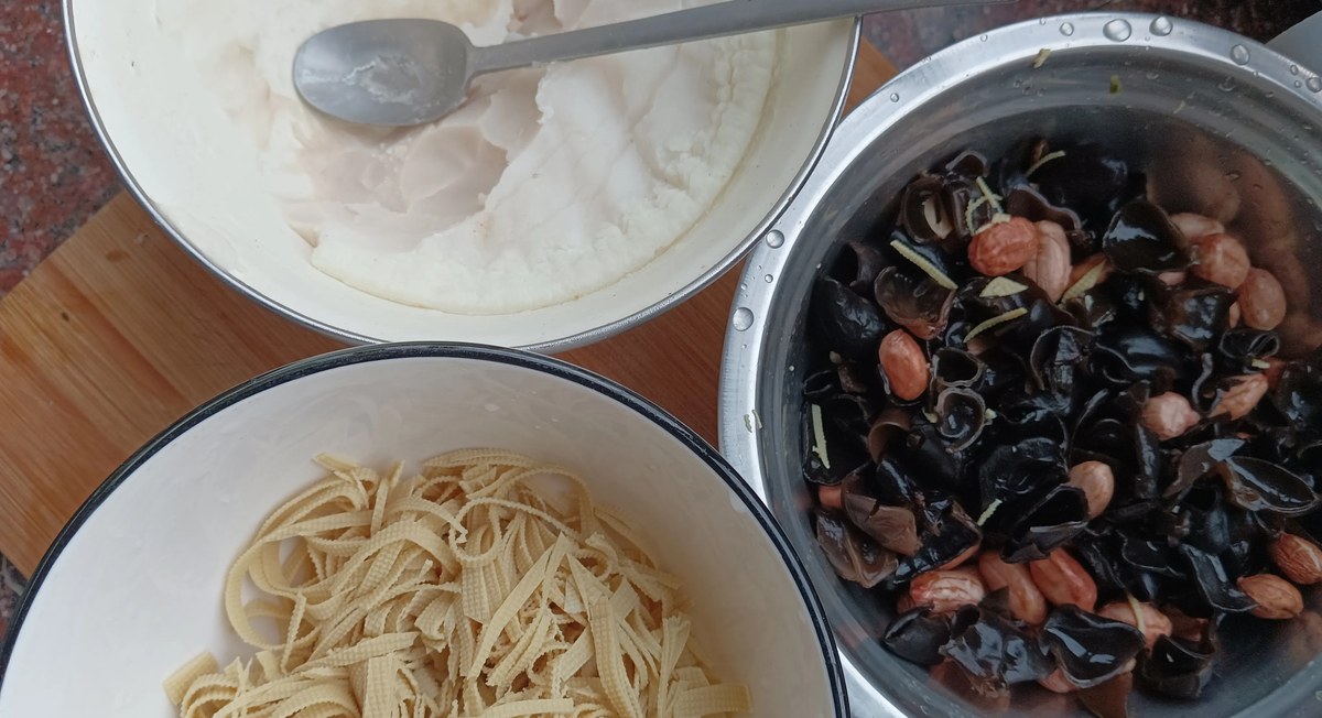 Hu La Tang ingredients laid out before cooking — a bowl of thick starch slurry, dried tofu skin strips, wood ear mushrooms and peanuts