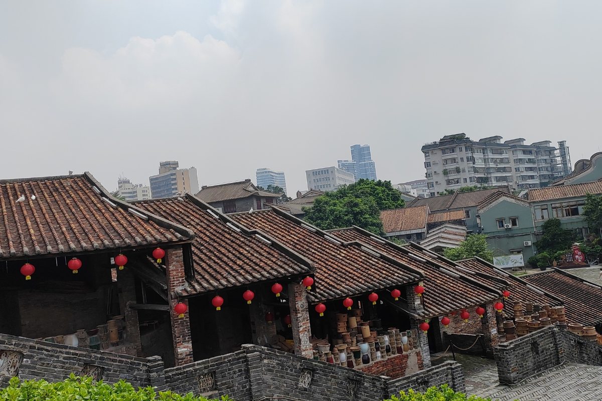 Traditional dragon kiln sheds stacked with unglazed clay jars at Shiwan, Foshan