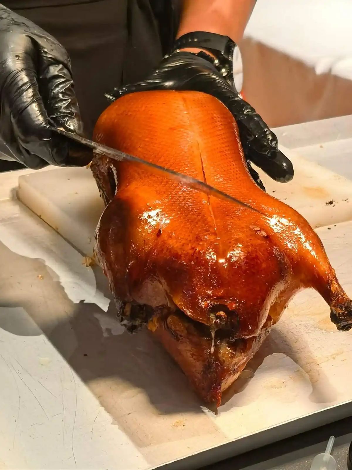 Whole Peking Duck — presentation before the cleaver falls