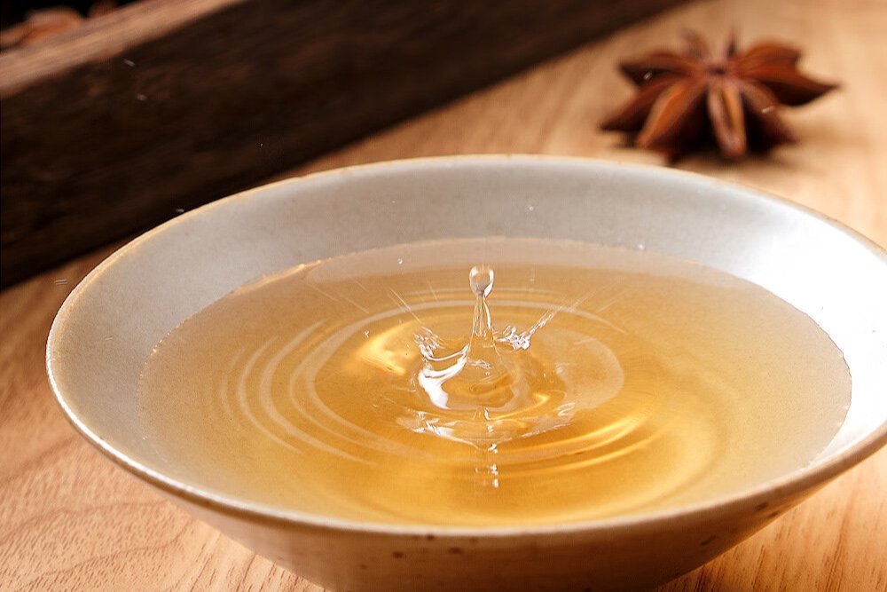 A bottle of Shaoxing cooking wine — amber-colored rice wine used for deglazing and marinating
