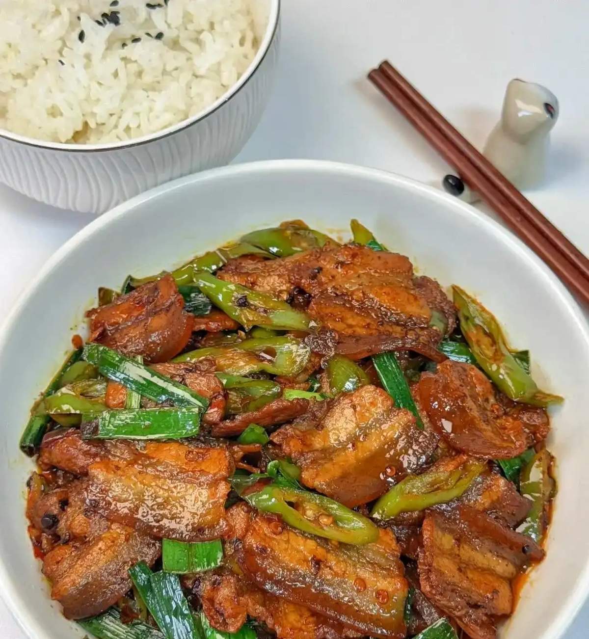Twice-Cooked Pork — served over steamed white rice with chili oil pooling at the bottom of the bowl