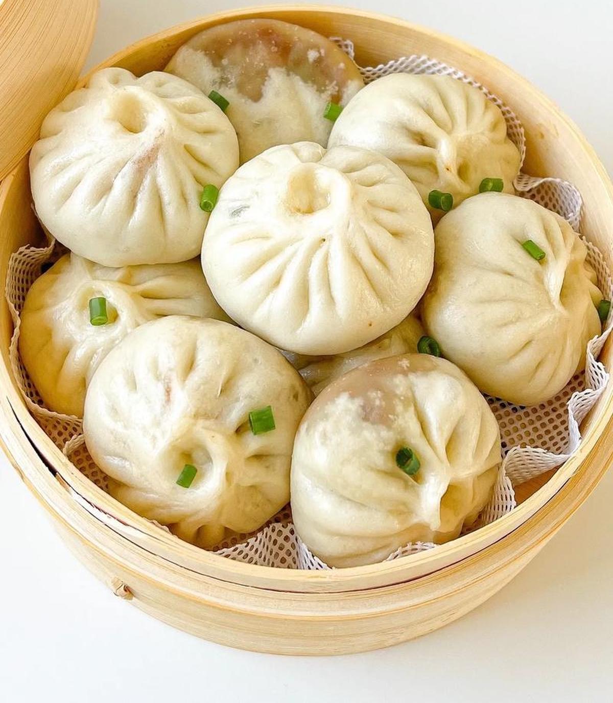 Xiao Long Bao being lifted from steamer