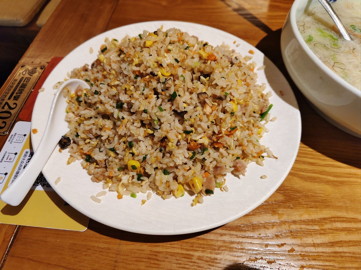 Yangzhou Fried Rice being eaten — spoon lifting a perfect bite of rice, char siu, shrimp, and scallion